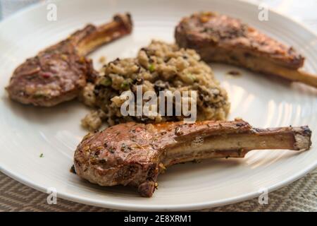 Marinated broiled lamb rib with cheesy mushroom risotto Stock Photo