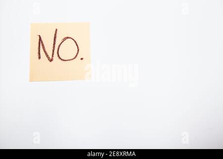 Text written NO on yellow note pad isolated Stock Photo
