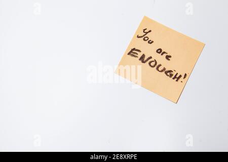 You are enough text written on yellow sticky note Stock Photo