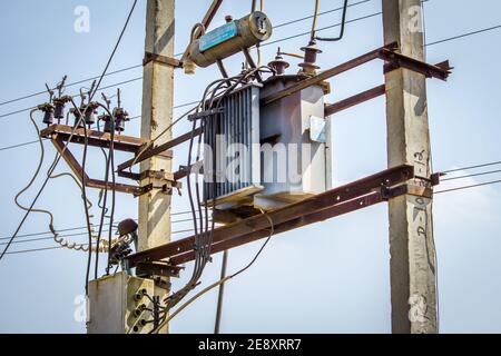 View of overhead electrical transformer in rural area, India Stock Photo