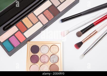 Top view close up of eyeshadow palletes and makeup brushes Stock Photo