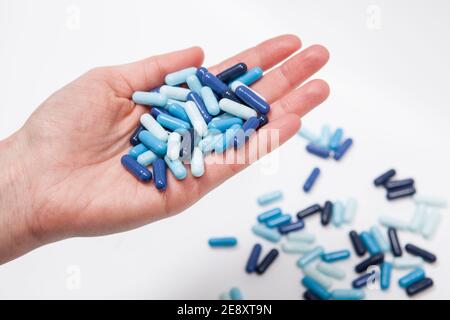 Cropped close up of blue medicament pills in the hand of unrecognizable person Stock Photo
