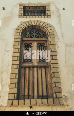 Low angle shot of an old arched wooden door Stock Photo