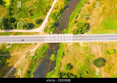 aerial drone shoot. Flying over a beautiful green forest in a rural landscape. Top view of trees in forest background. Drone photography. Forest river Stock Photo