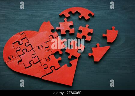 A broken heart made from puzzle pieces as a symbol of relationship problems. Stock Photo