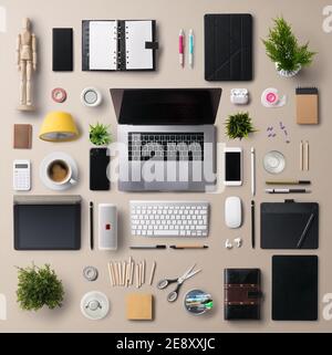 Flat lay top view office desk working space with laptop and office supplies on gray background. Stock Photo