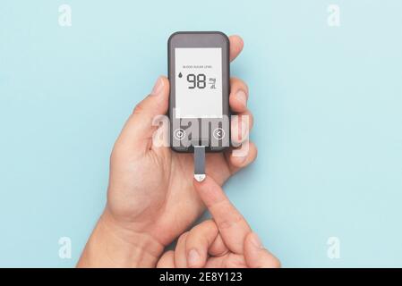 Man using glucometer, checking blood sugar level. Diabetes concept Stock Photo