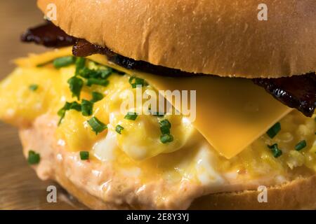 Homemade Bacon Egg Sandwich on a Brioche Bun with Cheese Stock Photo