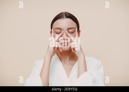 Young woman doing face building facial gymnastics self massage Stock Photo