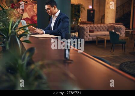 Stylish young man focused on his correspondence Stock Photo