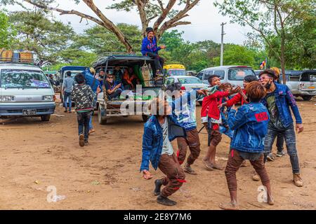 Bagan, Myanmar - January 1, 2017 : Myanmar youth havin a blast and dancing to music coming out from a car. Stock Photo