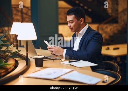 Concentrated Latin American man writing a text message Stock Photo