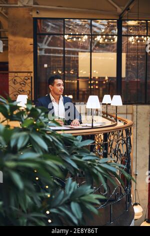 Dreamy male entrepreneur having a coffee break Stock Photo