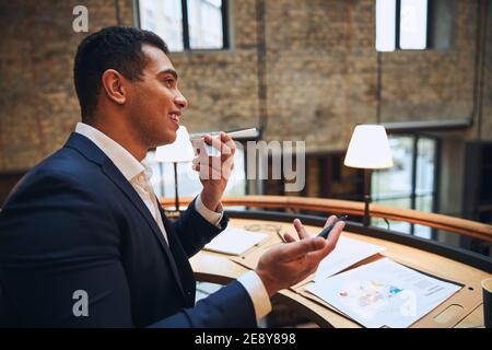 Joyful male entrepreneur speaking on the cellphone Stock Photo