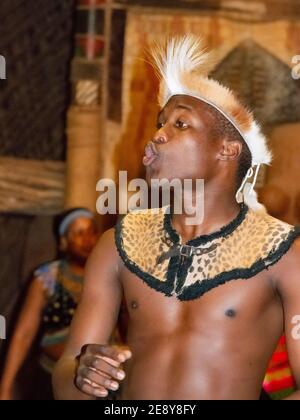 'Lips pursing'  zulu dance- troupe  performer  during a zulu dance at Shakaland Zulu Cultural Village in Eshowe,SA Stock Photo