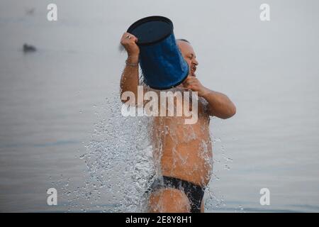 Outdoor shower and cold water bucket in a spa Stock Photo - Alamy