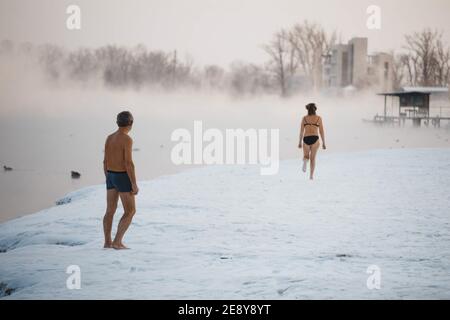 Moscow, Russia - January 15, 2019: Tempering with cold water. People walruses on the river bank in winter. Stock Photo