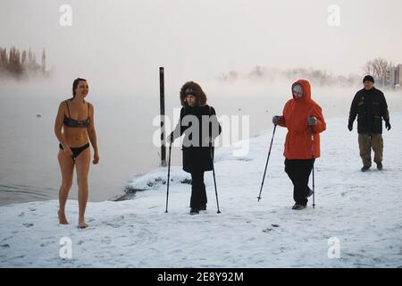 Moscow, Russia - January 15, 2019: Tempering with cold water. People walruses on the river bank in winter. Stock Photo