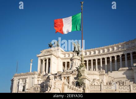 Altare della Patria in Rome and the flag of Italy with a beautiful blue sky Stock Photo