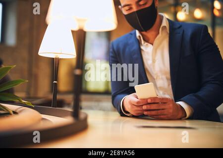 Focused serious businessman looking at his smartphone Stock Photo
