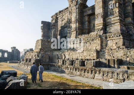 Ruins of the Martand Sun Temple under the sunlight and a blue sky in India Stock Photo