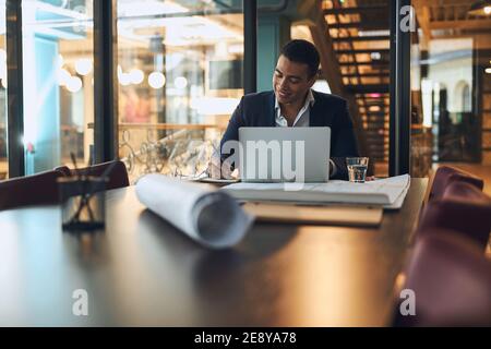 Joyful Latin American man taking notes with a pen Stock Photo