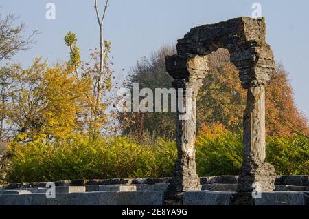 Ruins of the Martand Sun Temple under the sunlight and a blue sky in India Stock Photo