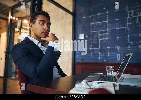 Pensive young engineer sitting at his computer Stock Photo