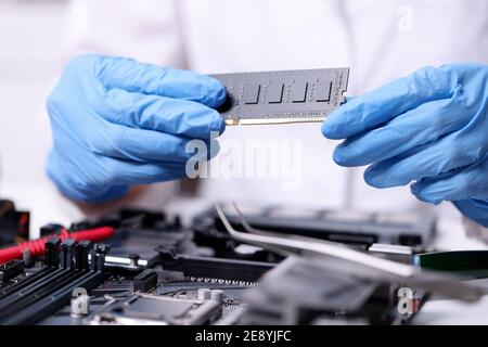 Technician hands in rubber gloves holding computers ram closeup Stock Photo
