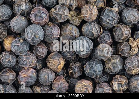 Macro closeup background of black pepper corn seeds Stock Photo