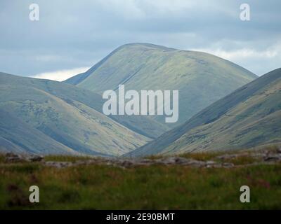 Summer dappled light on Green Bell, a peak in the Howgill Hills, seen from the Eden Valley in Cumbria, England, UK Stock Photo