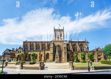 VIew of the front of local landmark, Sherborne Abbey (Abbey Church of St. Mary the Virgin) and the Digby Memorial, Sherborne, Dorset, in summer Stock Photo