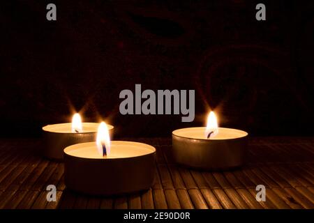 three candles in the dark with copy space Stock Photo