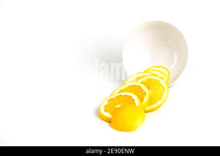 Isolated grapefruits slices out of a bowl. Grapefruit - circular slices of fresh grapefruit isolated on white background with copy space Stock Photo