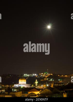 The full moon shines in the sky over the Dome of the Rock in Old Jerusalem night Stock Photo