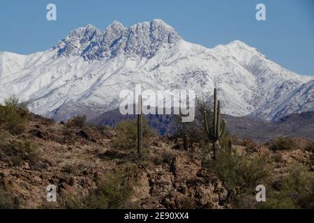 A winter storm covers the Four Peaks Mountains in snow in the Arizona desert wilderness outside the city of Phoenix. Stock Photo