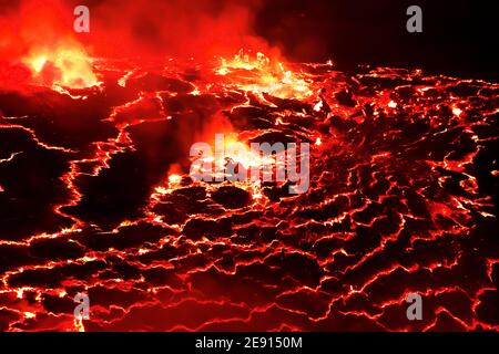 Mount Nyiragongo is an active stratovolcano with an elevation of 3,470 m, located in Virunga National Park. It contains the world's biggest lava lake. Stock Photo