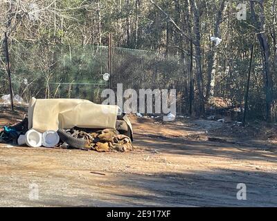 Burke County, Ga USA - 01 28 21: A rural county public waste trash dump for local residents trash pile toilet tire waste close up Stock Photo