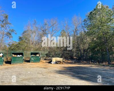 Burke County, Ga USA - 01 28 21: A rural county public waste trash dump for local residents trash pile toilet tire waste distant view Stock Photo