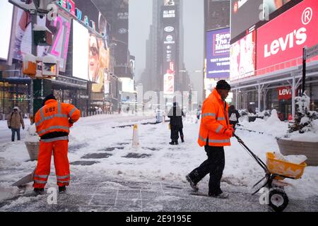 Workers clear the snow in Times Square during the storm on February 01, 2021 in New York City. The first nor'easter of 2021 has pummeled areas of the northern and central east coast including New York City, with over a foot of snow. Public transportation has been operating at a reduced schedule and coronavirus vaccination sites have been shut down, this possibly being the biggest storm surge since Superstorm Sandy in 2012. (Photo by John Lamparski?SIPA USA) Credit: Sipa USA/Alamy Live News Stock Photo