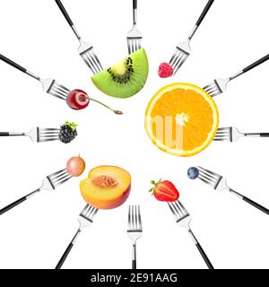 Different fruits impaled on forks against white background Stock Photo