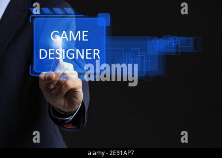 Male video games designer using virtual screen on dark background Stock Photo