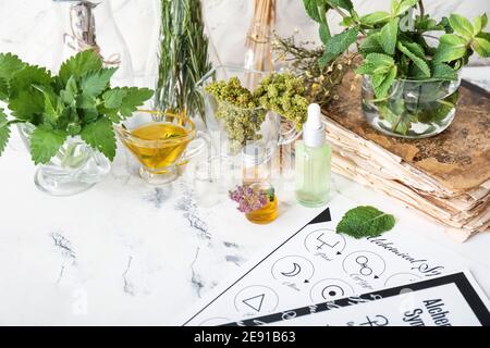 Alchemical symbols and ingredients for preparing potions on white background Stock Photo
