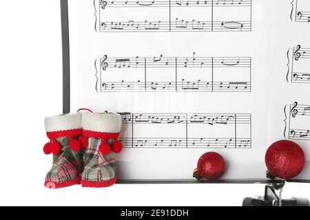 Music sheets with notes and Christmas decor on white background Stock Photo