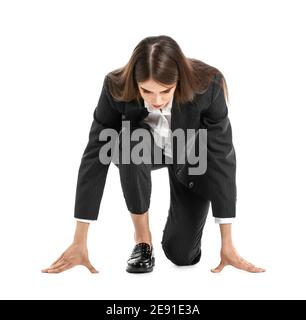 Young businesswoman standing in crouch start position isolated on white background Stock Photo