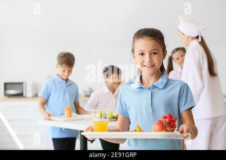 Schoolgirl having lunch in school canteen Stock Photo