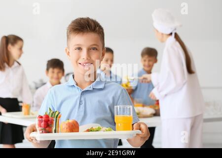 Schoolboy having lunch in school canteen Stock Photo