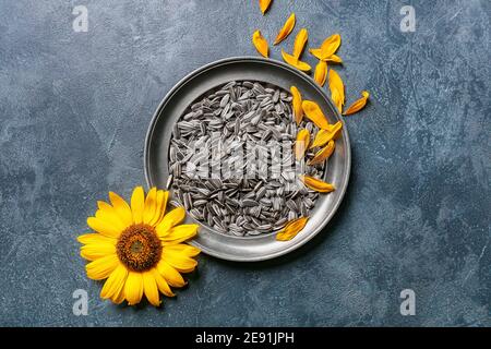 Plate with sunflower seeds on dark background Stock Photo