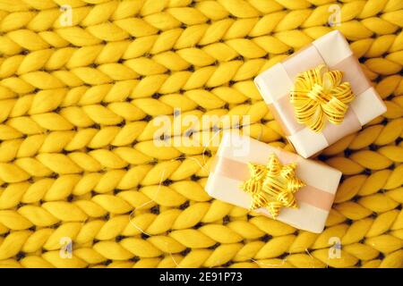 Gift boxes on knitted plaid, top view Stock Photo