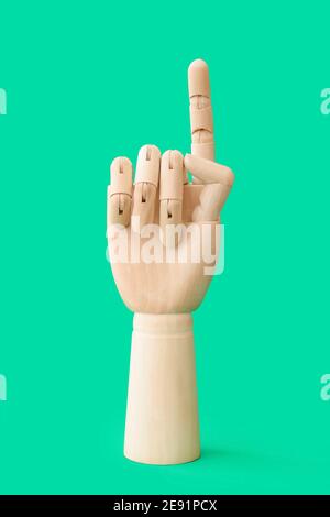 Wooden hand with raised index finger on white background Stock Photo ...